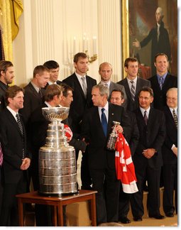 President George W. Bush thanks Detroit Red Wings player Chris Chelios for a miniature Stanley Cup presented to the President Tuesday, Oct. 14, 2008 in the East Room at the White House, during the ceremony to honor the Red Wings 2008 Stanley Cup championship. White House photo by Chris Greenberg