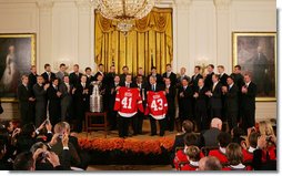 President George W. Bush stands with Detroit Red Wings captain Nicklas Lidstrom as they hold up jerseys Tuesday, Oct. 14, 2008 in the East Room at the White House, representing President Bush's father 41 and the President 43, during the ceremony to honor the Red Wings 2008 Stanley Cup championship. White House photo by Chris Greenberg