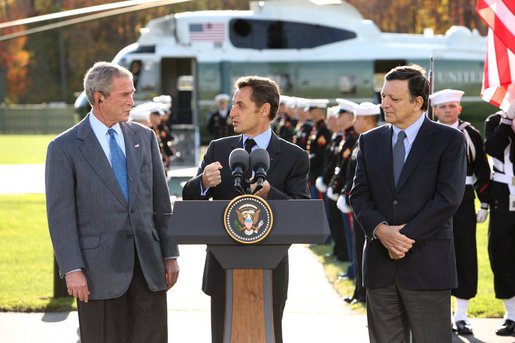 President George W. Bush listens as French President Nicolas Sarkozy, center, adresses the media during a meeting at Camp David to discuss the economic crisis and the need for coordinated global response, Saturday, October 18, 2008. The two presidents are joined by Jose Manuel Barroso, President of the European Commission, at right. White House photo by Chris Greenberg