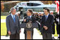 President George W. Bush listens as French President Nicolas Sarkozy, center, adresses the media during a meeting at Camp David to discuss the economic crisis and the need for coordinated global response, Saturday, October 18, 2008. The two presidents are joined by Jose Manuel Barroso, President of the European Commission, at right. White House photo by Chris Greenberg