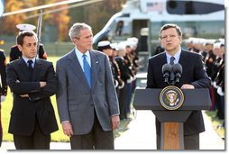 President George W. Bush and French President Nicolas Sarkozy, right, listen as Jose Manuel Barroso, President of the European Commission adresses the media during a meeting at Camp David to discuss the economic crisis and the need for coordinated global response, Saturday, October 18, 2008.  White House photo by Chris Greenberg