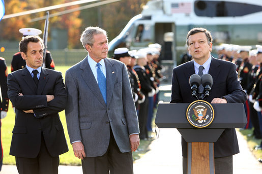 President George W. Bush and French President Nicolas Sarkozy, right, listen as Jose Manuel Barroso, President of the European Commission adresses the media during a meeting at Camp David to discuss the economic crisis and the need for coordinated global response, Saturday, October 18, 2008. White House photo by Chris Greenberg