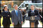 President George W. Bush and French President Nicolas Sarkozy, right, listen as Jose Manuel Barroso, President of the European Commission adresses the media during a meeting at Camp David to discuss the economic crisis and the need for coordinated global response, Saturday, October 18, 2008. White House photo by Chris Greenberg