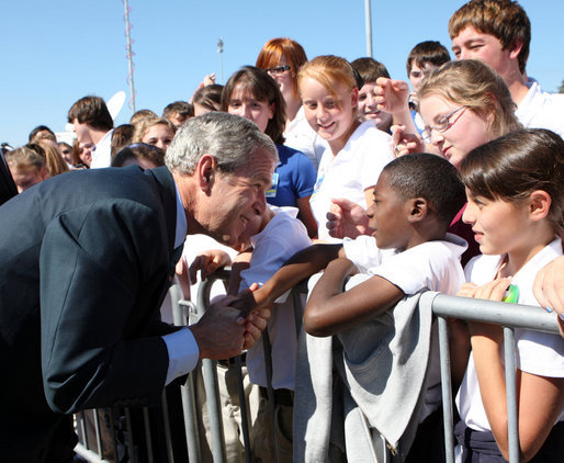 President George W. Bush shakes hands with a young boy as he arrives at Alexandria International Airport - Air National Guard Base Monday, Oct. 20, 2008, in Alexandria, Louisiana. White House photo by Chris Greenberg