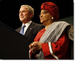 President George W. Bush stands with Liberian President Ellen Johnson Sirleaf before delivering his remarks at the White House Summit on International Development Tuesday, Oct. 21, 2008, in Washington, D.C. President Bush discussed in his remarks core transformational goals of country ownership, good governance, results-based programs and accountability, and the importance of economic growth. White House photo by Eric Draper