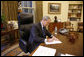 President George W. Bush fills out his ballot for the 2008 election during the early voting process from his Oval Office desk at the White House Friday, Oct. 24, 2008. Ballots cast by both the President and Mrs. Laura Bush will be mailed back to Texas today. White House photo by Eric Draper