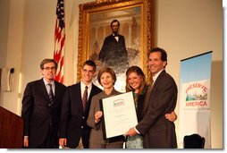 Mrs. Laura Bush presents the Fifth Annual Preserve America History Teacher of the Year award to David Mitchell, right, Friday, Oct. 24, 2008, at the Union League Club in New York City. She is joined by Dr. James Basker, President, Gilder Lehrman Institute of American History, left, and David Mitchell's students from Masconomet Regional High School in Boxford, Mass., David Burbank, 17, and Molly Byman, 18. The award notes the importance of teaching history and highlights the Preserve America initiative. White House photo by Chris Greenberg