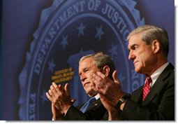 President George W. Bush and FBI Director Robert Mueller applaud the class speaker Thursday, Oct. 30, 2008, at the graduation ceremony for FBI special agents in Quantico, Va. President Bush addressed the graduates and thanked them for stepping forward to serve their country. White House photo by Joyce N. Boghosian