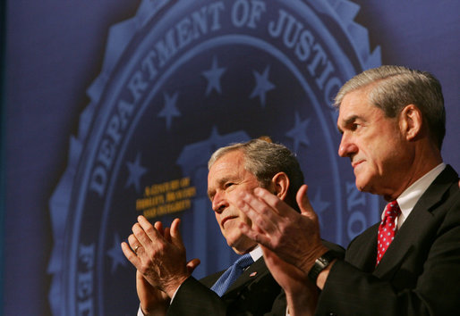 President George W. Bush and FBI Director Robert Mueller applaud the class speaker Thursday, Oct. 30, 2008, at the graduation ceremony for FBI special agents in Quantico, Va. President Bush addressed the graduates and thanked them for stepping forward to serve their country. White House photo by Joyce N. Boghosian