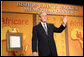 President George W. Bush waves as he acknowledges applause following his remarks Wednesday evening, Nov. 12, 2008, at the 2008 Bishop John T. Walker Memorial Dinner in Washington, D.C., where President Bush was honored with the Bishop John T. Walker Distinguished Humanitarian Service Award from Africare. White House photo by Chris Greenberg