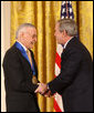 President George W. Bush congratulates legendary comic book creator Stan Lee of Los Angeles, as a recipient of the 2008 National Medal of Arts in ceremonies Monday, Nov. 17, 2008 at the White House. White House photo by Chris Greenberg