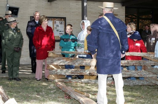 Mrs. Laura Bush watches with children as a reenactor demonstrates rail splitting during her visit to the Abraham Lincoln Birthplace National Historical Site Tuesday, Nov. 18, 2008, in Hodgenville, KY. White House photo by Joyce N. Boghosian