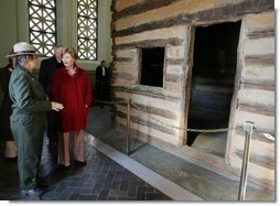 Mrs. Laura Bush tours a replica Log Cabin of Abraham Lincoln's Birthplace during her visit to the Abraham Lincoln Birthplace National Historic Site Tuesday, Nov. 18, 2008, in Hodgenville, KY. Mrs. Bush is led on the tour by Ms. Sandy Brue, Chief of Interpretation and Resource Management, Abraham Lincoln Birthplace National Historic Site.  White House photo by Joyce N. Boghosian