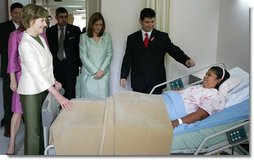 Mrs. Laura Bush spends a moment with Ms. Robalba Robinson, a breast cancer patient recovering from recent reconstructive surgery, during a visit Friday, Nov. 21, 2008, to the National Oncology Institute in Panama City. Joining her is Mrs. Vivian Fernandez de Torrijos, First Lady of Panama, in pink, and Dr. Rosario Turner, Panama's Minister of Health. The man at right is unidentified. White House photo by Joyce N. Boghosian