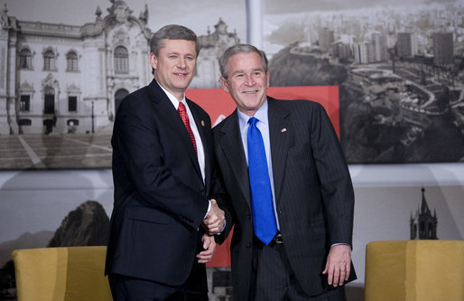 President George W. Bush and Prime Minister Stephen Harper of Canada smile for the cameras during a greeting Saturday, Nov. 22, 2008, prior to the their meeting in Lima, Peru. White House photo by Eric Draper