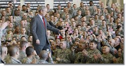 President George W. Bush acknowledges his audience as he enters the staging area Tuesday, Nov. 25, 2008, at Fort Campbell, Ky., home of the 101st Airborne. The President told the troops, "We are blessed to have defenders of such character and courage. I'm grateful to the families who serve by your side. And I will always be thankful for the honor of having served as the Commander-in-Chief." White House photo by Eric Draper