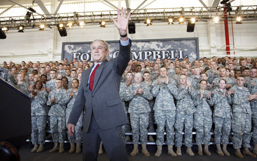 President George W. Bush waves to the troops at Fort Campbell, Ky., Tuesday, Nov. 25, 2008, after being introduced on stage during a Thanksgiving visit. Said the President, "Over the past seven years, folks from this base have done exactly what they were trained to do." "You have taken the battle of the terrorists overseas so we do not have to face them here in the United States. You have helped counter the hateful ideology of tyranny and terror with a more hopeful vision of justice and liberty. You're part of the great ideological struggle of our time. With the soldiers of Fort Campbell out front, the forces of freedom and liberty will prevail." White House photo by Eric Draper