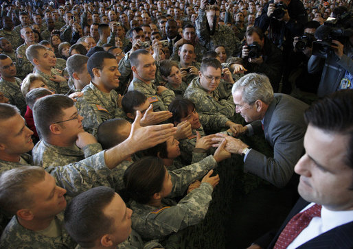 President George W. Bush greets his audience Tuesday, Nov. 25, 2008, after addressing the troops at Fort Campbell, Ky. Said the President, "I'm honored to be with the Screaming Eagles of the 101st Airborne; the Night Stalkers of the 160th; the Green Berets of the 5th Special Forces Group, all members of the Fort Campbell community. You are part of the finest military in the world. I have one word for you: Hooah!" White House photo by Eric Draper