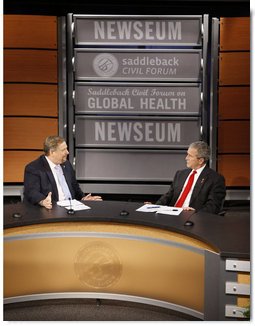 President George W. Bush speaks with Pastor Rick Warren Monday, Dec. 1, 2008, during President Bush's participation at the Saddleback Civil Forum on Global Health at the Newseum in Washington, D.C. White House photo by Eric Draper