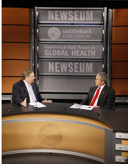 President George W. Bush speaks with Pastor Rick Warren Monday, Dec. 1, 2008, during President Bush's participation at the Saddleback Civil Forum on Global Health at the Newseum in Washington, D.C. White House photo by Eric Draper