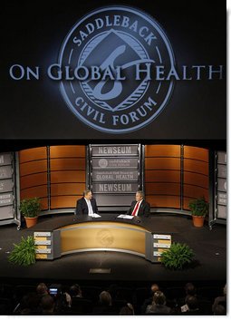 President George W. Bush speaks with Pastor Rick Warren Monday, Dec. 1, 2008, during President Bush's participation at the Saddleback Civil Forum on Global Health at the Newseum in Washington, D.C. White House photo by Eric Draper