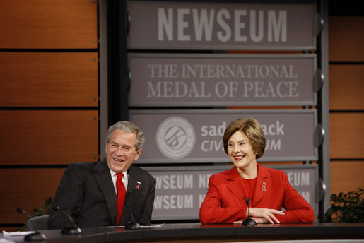 President George W. Bush and Mrs. Laura Bush react during a question and answer session Monday, Dec. 1, 2008, at the Saddleback Civil Forum on Global Health at the Newseum in Washington, D.C. White House photo by Eric Draper