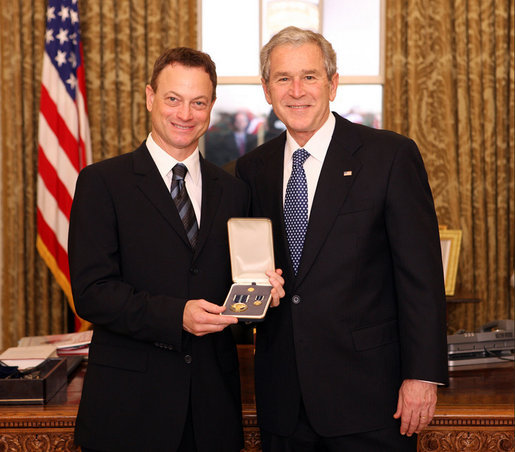 President George W. Bush stands with Gary Sinise after presenting him with the 2008 Presidential Citizens Medal Wednesday, Dec. 10, 2008, in the Oval Office of the White House. White House photo by Chris Greenberg