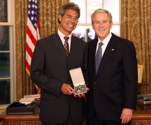 President George W. Bush stands with Dr. Mitch Besser after presenting him with the 2008 Presidential Citizens Medal Wednesday, Dec. 10, 2008, in the Oval Office of the White House. White House photo by Chris Greenberg