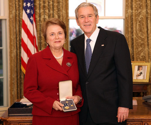 President George W. Bush stands with Dr. Anne M. Radice after presenting her with the 2008 Presidential Citizens Medal Wednesday, Dec. 10, 2008, in the Oval Office of the White House. White House photo by Chris Greenberg