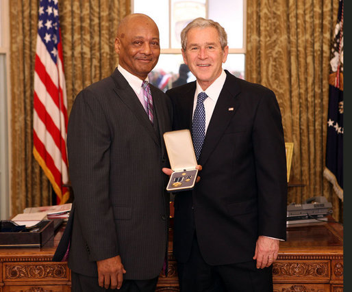 President George W. Bush stands with Bob Woodson, Sr., after presenting him with the 2008 Presidential Citizens Medal Wednesday, Dec. 10, 2008, in the Oval Office of the White House. White House photo by Chris Greenberg