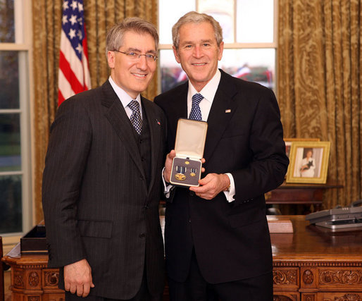 President George W. Bush stands with Robert "Robby" P. George after presenting him with the 2008 Presidential Citizens Medal Wednesday, Dec. 10, 2008, in the Oval Office of the White House. White House photo by Chris Greenberg