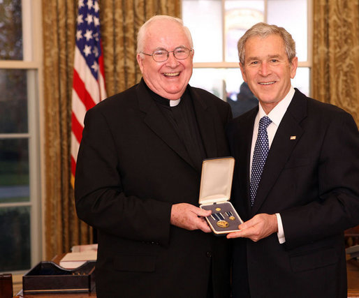 President George W. Bush stands with Father John P. Foley, S.J., after presenting him with the 2008 Presidential Citizens Medal Wednesday, Dec. 10, 2008, in the Oval Office of the White House. White House photo by Chris Greenberg