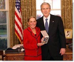 President George W. Bush stands with Kathy Downing after presenting her with the 2008 Presidential Citizens Medal Wednesday, Dec. 10, 2008, on behalf of her husband Gen. Wayne A. Downing, in the Oval Office of the White House. White House photo by Chris Greenberg