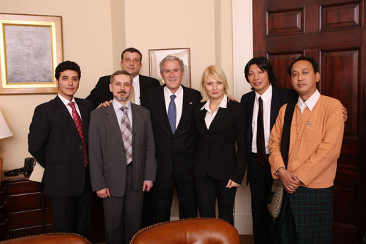 President George W. Bush poses for a photo with international bloggers and new media users following their meeting on human rights Wednesday, Dec. 10, 2008, in the Roosevelt Room at the White House. White House photo by Chris Greenberg