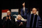 With former President George H.W. Bush and Mrs. Barbara Bush looking on, President George W. Bush gives the thumbs-up to the audience as he stands onstage Friday, Dec. 12, 2008, in Reed Arena where he delivered the commencement address at Texas A& M University in College Station, Texas. White House photo by Eric Draper