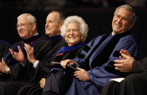 President George W. Bush enjoys the moment with his mom, Mrs. Barbara Bush, and dad, former President George H.W. Bush, as they sit on stage at Reed Arena on the campus of Texas A&M University where the President addressed the 3,700 graduates of the school's Winter Class of 2008. White House photo by Eric Draper