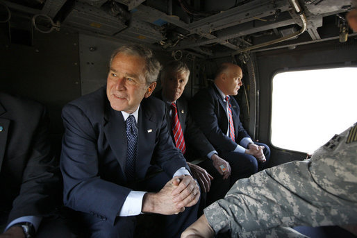 President George W. Bush, joined by U.S. Ambassador to Iraq Ryan Crocker, center, rides in a military helicopter Sunday, Dec. 14. 2008, from Baghdad International Airport to Salam Palace in Baghdad, where President Bush met with Iraqi leaders. White House photo by Eric Draper