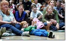 Children, their families and staff at Children's National Medical Center in Washington, D.C. watch the debut of Barney Cam VII: A Red, White & Blue Christmas, which Mrs. Laura Bush debuted Monday, Dec. 15, 2008 during her annual visit to the hospital. The crowd got to see the video about the Bush pets - dogs Barney and Miss Beazley and Willard the cat - which can be seen on the White House web site. Mrs. Bush read the book "My Penguin Osbert" to the group and visited patients.  White House photo by Joyce N. Boghosian