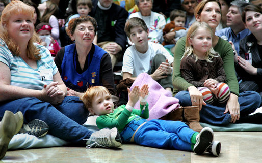 Children, their families and staff at Children's National Medical Center in Washington, D.C. watch the debut of Barney Cam VII: A Red, White & Blue Christmas, which Mrs. Laura Bush debuted Monday, Dec. 15, 2008 during her annual visit to the hospital. The crowd got to see the video about the Bush pets - dogs Barney and Miss Beazley and Willard the cat - which can be seen on the White House web site. Mrs. Bush read the book "My Penguin Osbert" to the group and visited patients. White House photo by Joyce N. Boghosian