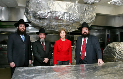 Mrs. Laura Bush poses Monday, Dec. 15, 2008, in the White House kitchen with the rabbis who supervised the kitchen's koshering for the annual Hanukkah party. From left are Rabbi Mendel Minkowitz, Rabbi Binyomin Steinmetz and Rabbi Levi Shemtov. White House photo by Joyce N. Boghosian