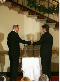 Clifton Truman Daniel, right, and Yariv Ben-Eliezer light the Menorah Monday, Dec. 15, 2008, before the annual White House Hanukkah Reception. Because the Menorah was being lit before the holiday actually begins, December 21, all eight candles, plus the Shamash -- the main candle -- were lit following a blessing.  White House photo by Shealah Craighead