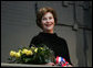 Mrs. Laura Bush stands with a bouquet presented along with the Department of Defense Outstanding Public Service Award by U.S. Secretary of Defense Robert Gates during a military appreciation Tuesday, Jan. 6, 2009, in honor of President George W. Bush's tenure as Commander-in-Chief. White House photo by Joyce N. Boghosian