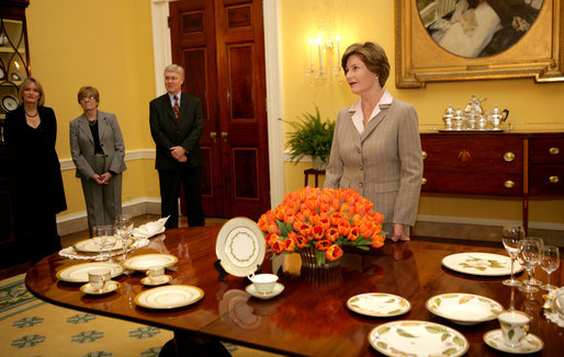 Mrs. Laura Bush meets reporters as she announces two new White House china patterns, Wednesday, Jan. 7, 2009 in the Family Dining Room of the State Floor of the White House for their unveiling of the George W. Bush State China and the Magnolia Residence China. The George W. Bush State China was inspired from a Madison-era dinner service. The Magnolia Residence China is in the picture foreground and the George W. Bush State China is on the left side of the table. With Mrs. Bush from left are Amy Zantzinger, White House Social Secretary, Nancy Clarke, White House Florist, and Bill Allman, White House Curator. White House photo by Shealah Craighead