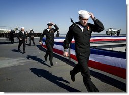 The crew of the USS George H.W. Bush (CVN 77) aircraft carrier ceremonially run aboard as the ship "comes alive" Saturday, Jan. 10, 2009, during commissioning ceremonies in Norfolk, Va. White House photo by David Bohrer