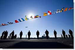 U.S. Navy Sailors line the deck of the the USS George H.W. Bush (CVN 77) aircraft carrier as a World War II Avenger Torpedo bomber similar to the plane flown by former President George H.W. Bush does a flyby Saturday, Jan. 10, 2009, during commissioning ceremonies in Norfolk, Va. White House photo by David Bohrer