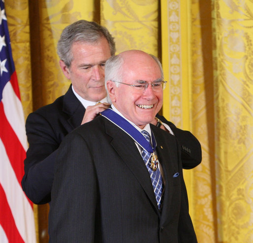 Former Prime Minister John Howard of Australia, smiles as President George W. Bush presents him with the 2009 Presidential Medal of Freedom Tuesday, Jan. 13, 2009, during ceremonies in the East Room of the White House. Established in 1963, the Medal may be presented to "any person who has made an especially meritorious contribution to the security or national interests of the United States, or world peace or cultural or other significant public or private endeavors." White House photo by Chris Greenberg