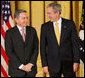 President George W. Bush stands with Colombian President Alvaro Uribe Tuesday, Jan. 13, 2009, during ceremonies honoring the 2009 Presidential Medal of Freedom Recipients in the East Room of the White House. White House photo by Chris Greenberg