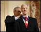 President George W. Bush places the Presidential Medal of Freedom to U.S. Ambassador to Iraq Ryan Crocker during a ceremony Thursday, Jan. 15, 2009, at the U.S. Department of State to commemorate foreign policy achievements. White House photo by Eric Draper