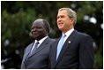 Presidents Bush and Kibaki watch the military review portion of the State Arrival Ceremonies on the South Lawn of the White House Monday, October 5, 2003.