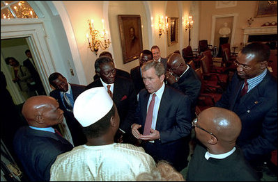 President George W. Bush meets with President John Kufuor of Ghana, left, President Abdoulaye Wade of Senegal, far left, and President Oumar Konare of Mali, center, in the Cabinet Room June 28, 2001. President Bush's pledge of assistance and quick response helped Ghana recover from a flood emergency at that time.